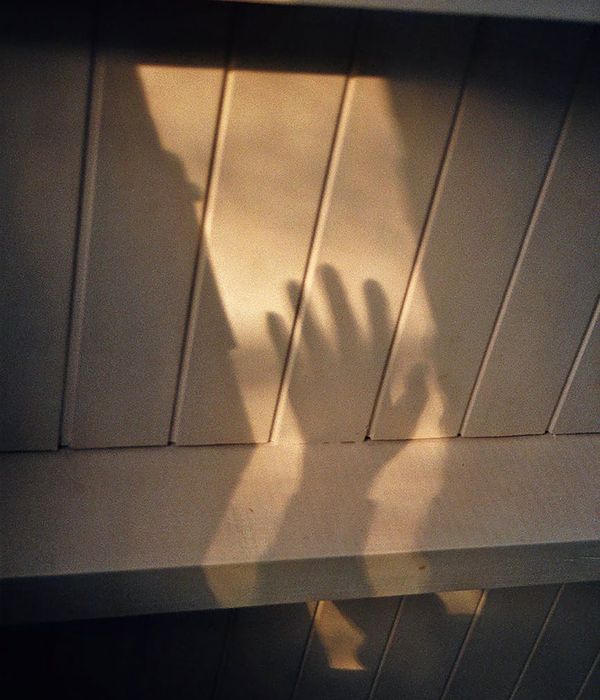 Close-up of a textured yoga mat on a wooden floor with soft ambient light.